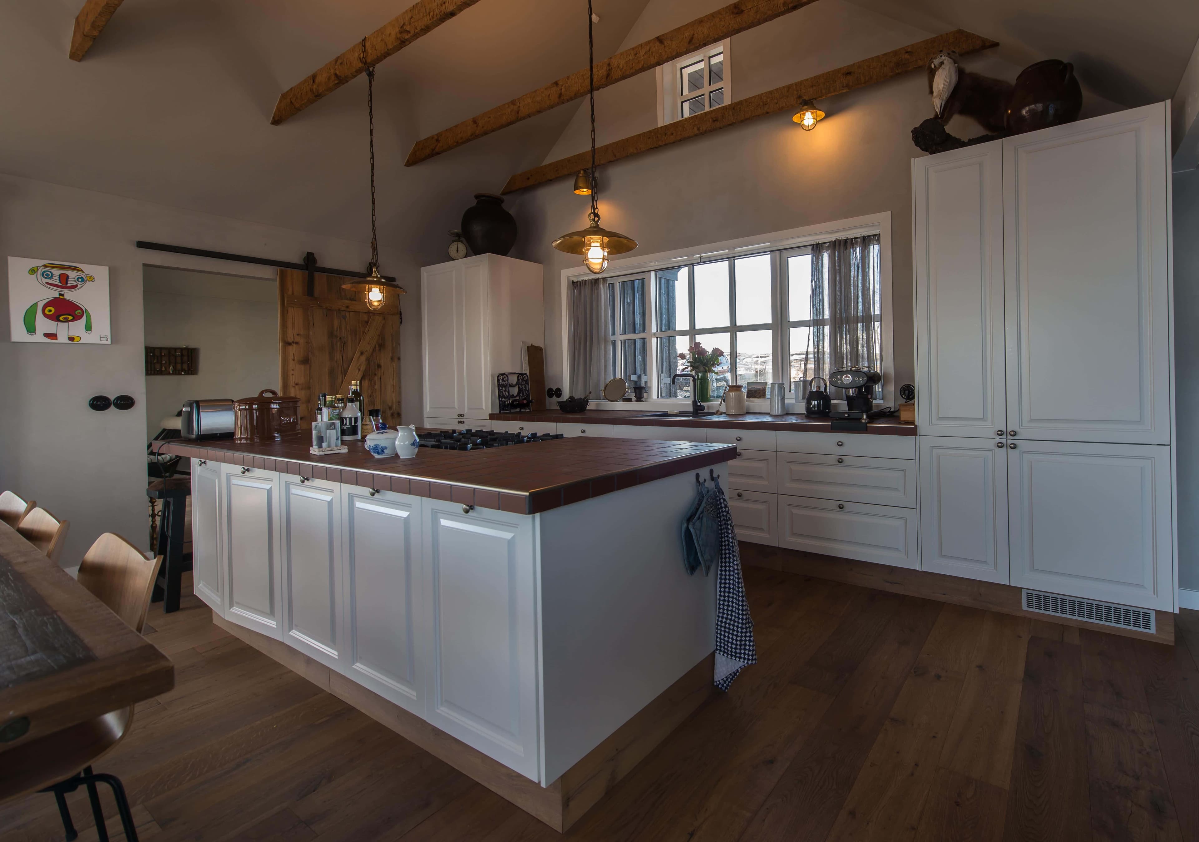 Modern kitchen with a stovetop on a central island and dining area